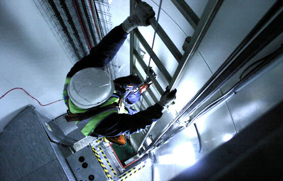 Fall Arrest Protection With Cable Lifeline Inside Shaft Attached to Ladder