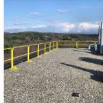 Rooftop guardrail installation in modular configuration on a flat roof.