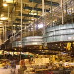 Debris Containment Nets on Moving Conveyor Belts