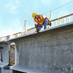 Custom engineered horizontal cable lifelines for roof-edge fall protection.