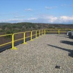 Custom engineered and fabricated roof edge rail systems on the rooftop for a defense and aerospace contractor.