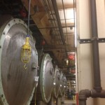 Installation of anchor points atop mixing and chemical tanks for a Fortune 500 food processing company using steel or beam-trolley single-point anchors.